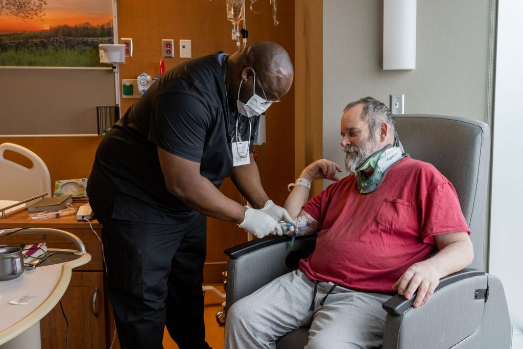 Nurse caring for patient in hospital room