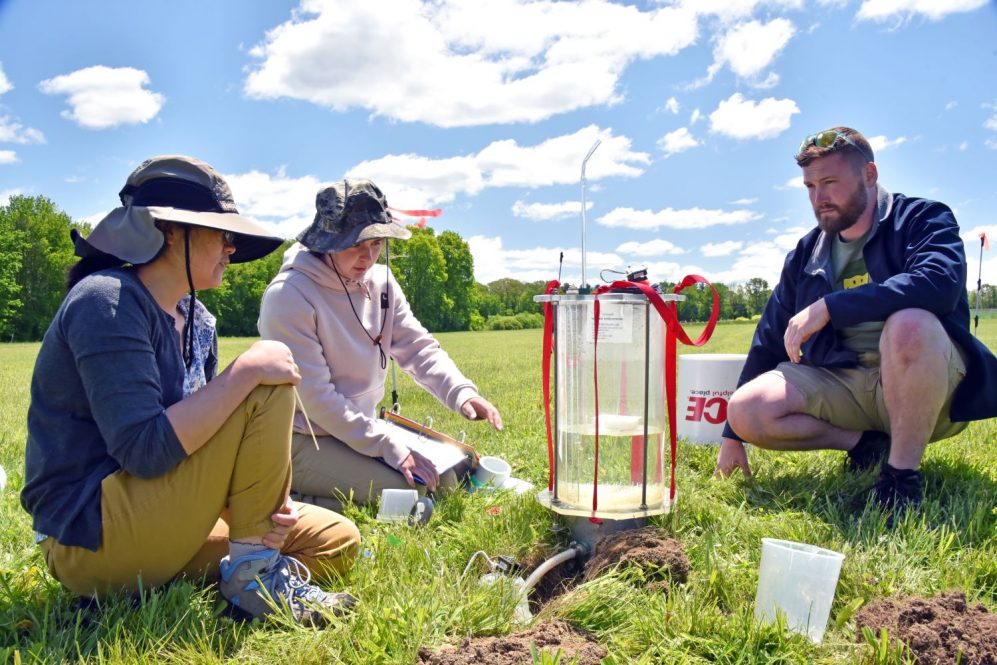 Student collect soil samples in the field