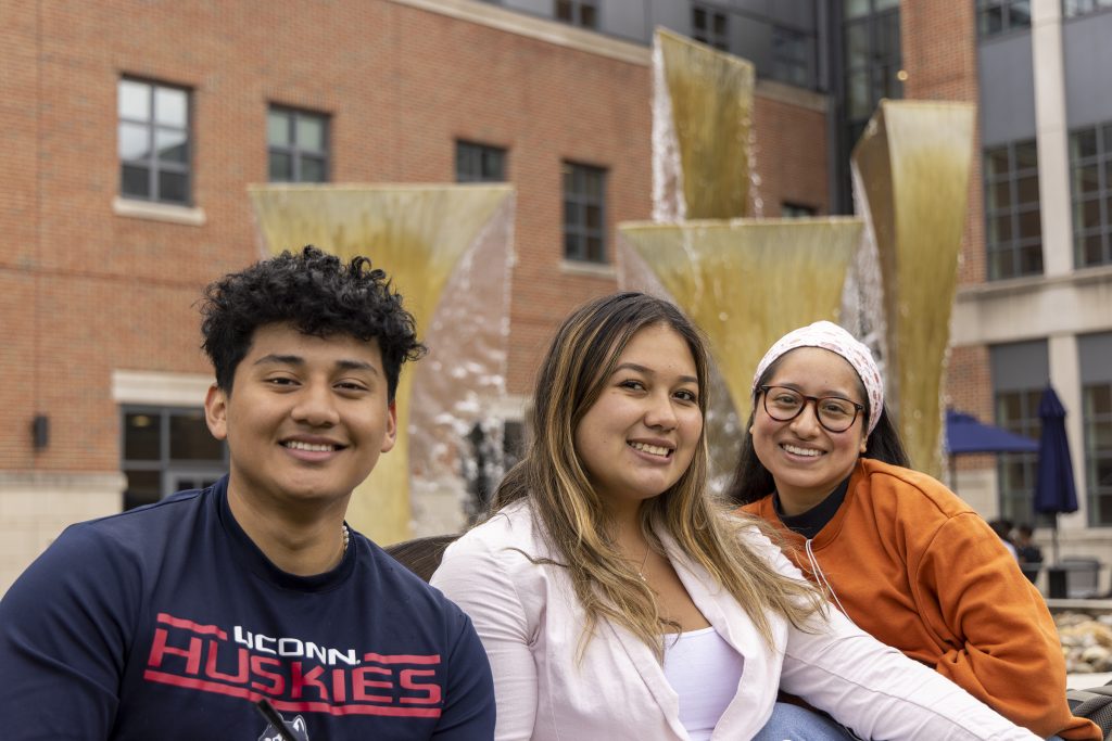 Three UConn CAHNR students smile at the camera.