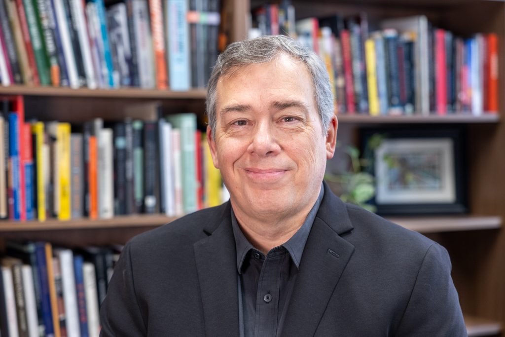 Jim Waller, who was recently appointed as the first Christopher J. Dodd Chair in Human Rights Practice at UConn, poses for a photo in his office in the Dodd Center for Human Rights