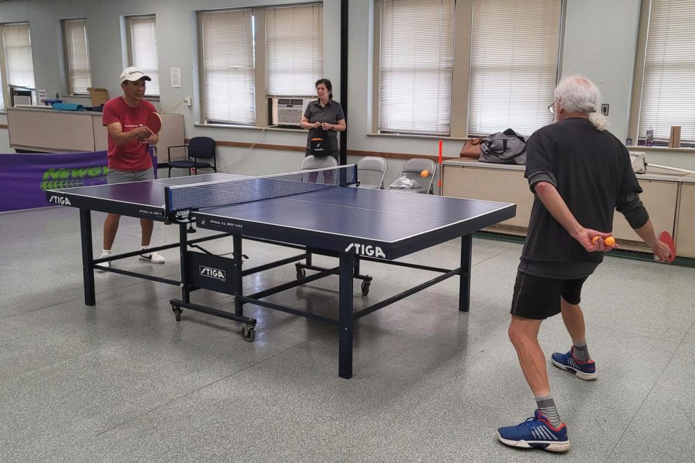 two men playing ping pong