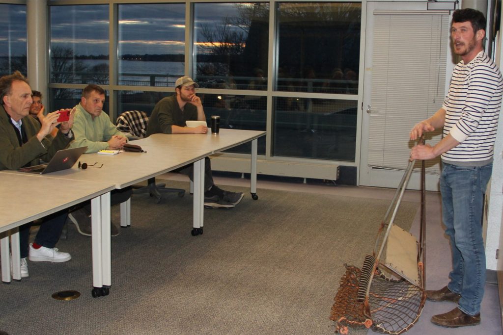 Michael Gilman shows an oyster dredge to students in the “Foundations of Shellfish Farming” class at UConn Avery Point