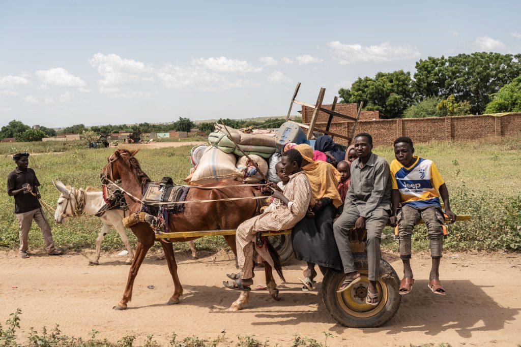 A Sudanese family sit on a cart after reaching Adre from the border of Sudan heading to the Adre camp, where around 200,000 people are currently taking refuge on September 19, 2023 in Adre, Chad. The conflict in Sudan, entering its sixth month, has left thousands of civilians dead and displaced more than five million people. More than 420,000 people have already found refuge in neighboring Chad as hundreds continue to arrive daily.