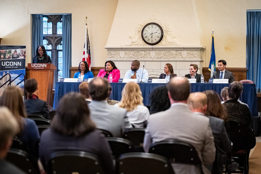 moderator and panelists in front of audience