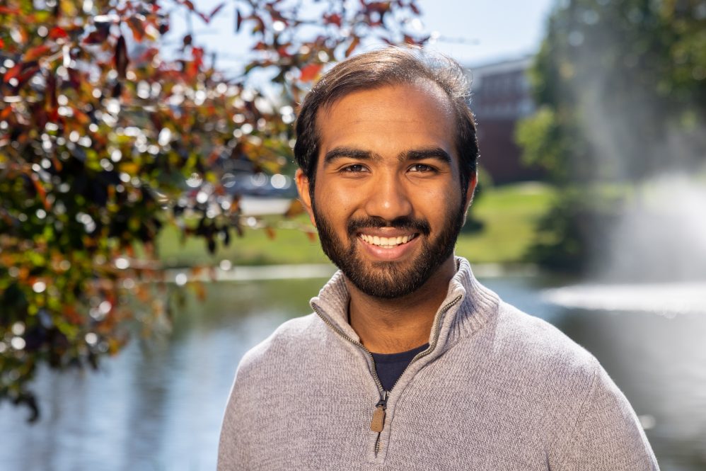 Chapal Bhavsar '26 poses for a photo next to Swan Lake