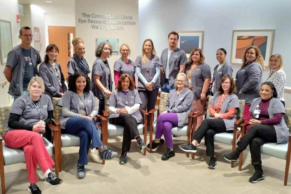 Group portrait of ophthalmology technicians in waiting room