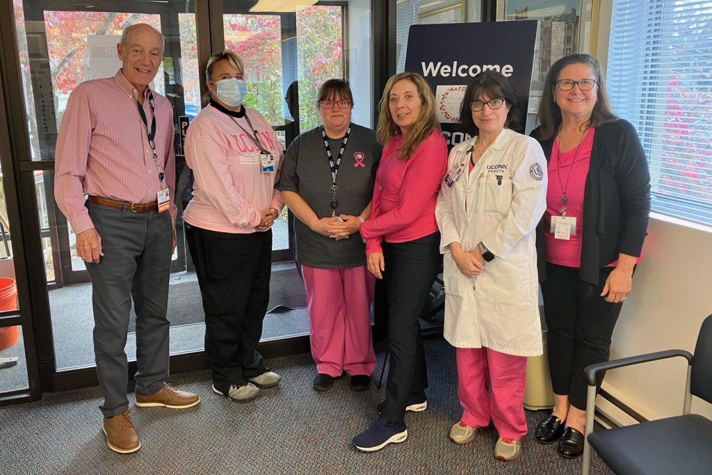 Group portrait of staff wearing pink