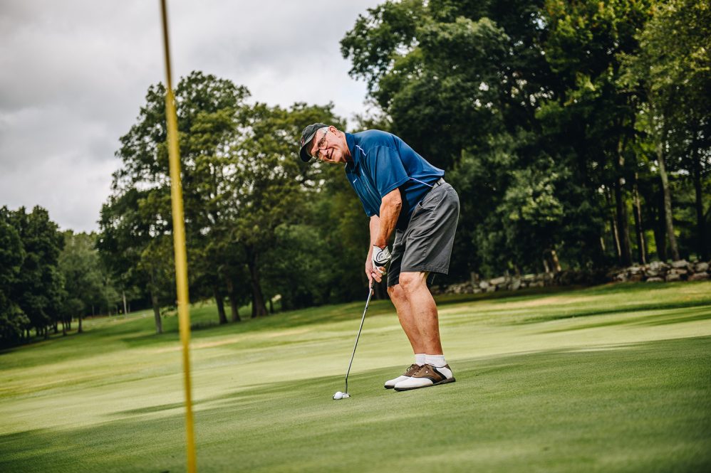 Larry Gramling posed for a photo on the golf course after his 2018 retirement. He said he was enjoying golf, time and travel with his family, and some civic projects. (Nathan Oldham / UConn School of Business)