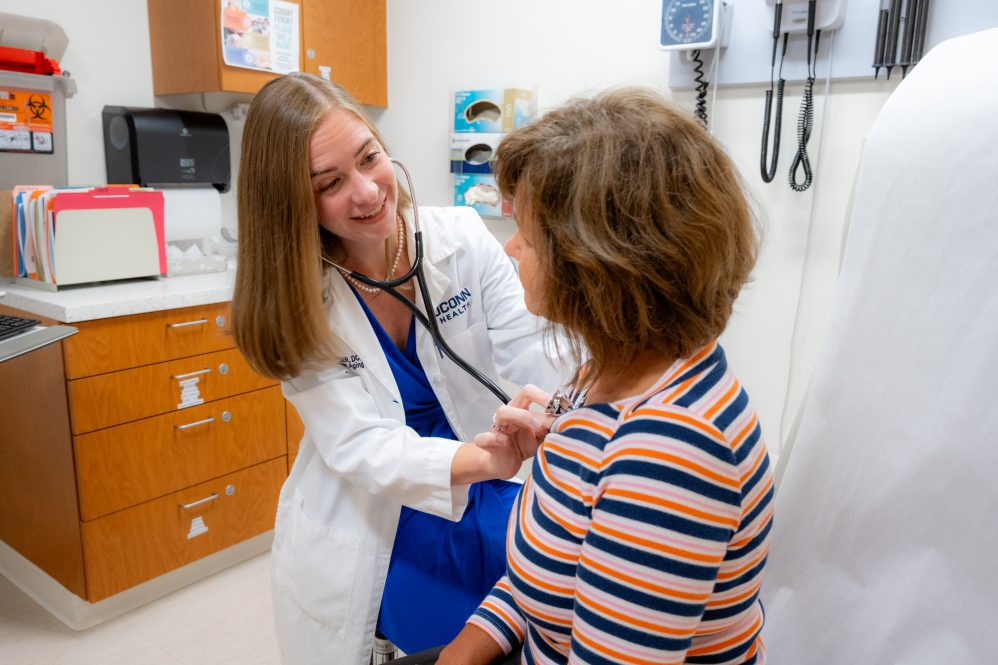 Dr. Jaclyn Jaeger with a stethoscope on a patient