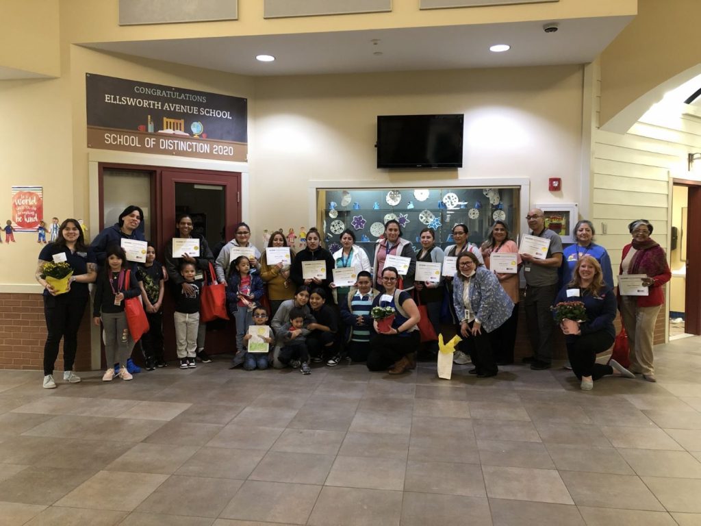 A group of students and educators poses for a photo