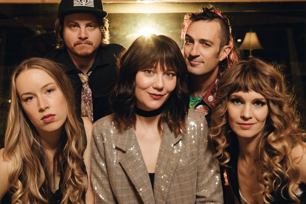 The bluegrass musician Molly Tuttle, surrounded by the members of her band, Golden Highway.