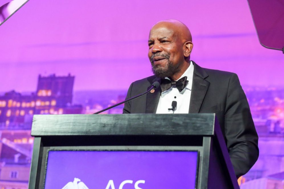 Dr. Laurencin speaking at an award ceremony, standing at a podium