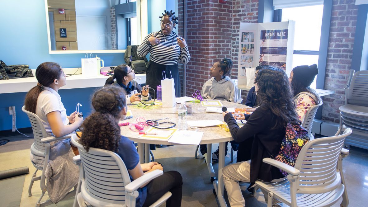 A UConn Waterbury student leads middle schoolers in one of the hands-on activities offered by the new program.