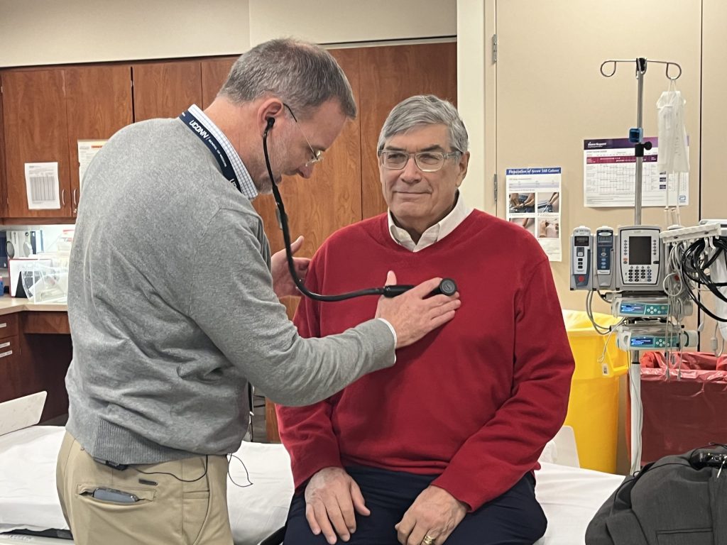 Dr. Pickett listening to patient Pete's heart.