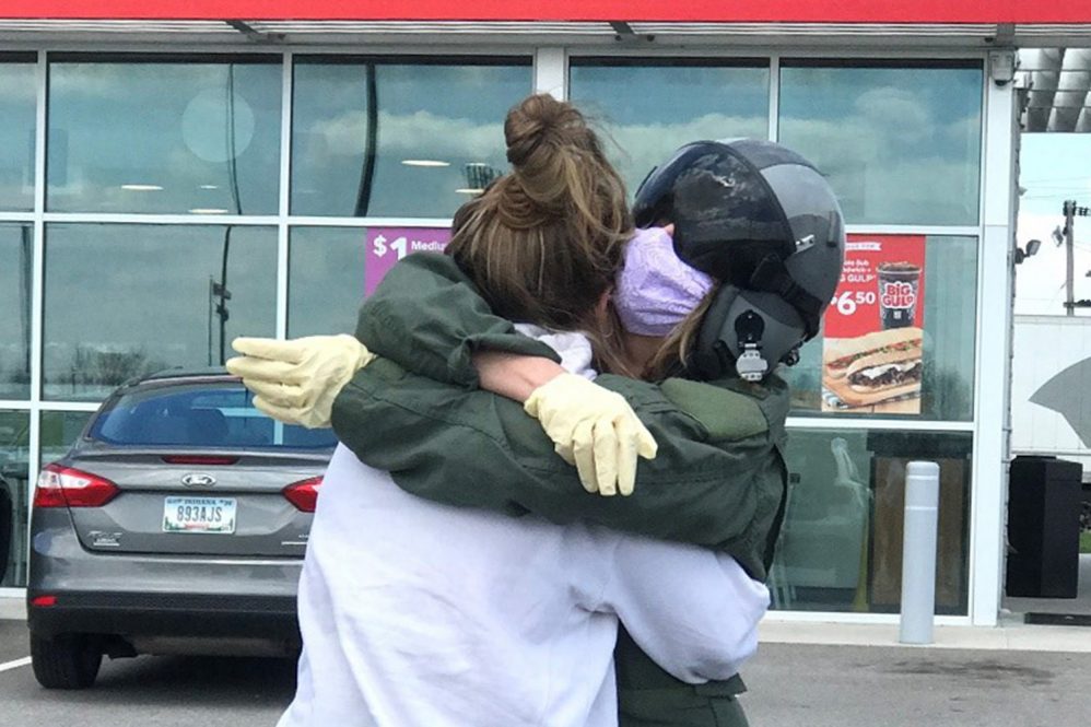 A mother hugging her daughter who had been working as an ICU nurse with strictly COVID prone vented patients for 4–6 weeks straight.