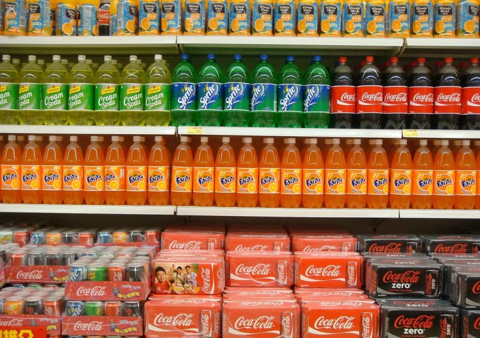 An aisle of sodas and juice at a supermarket.