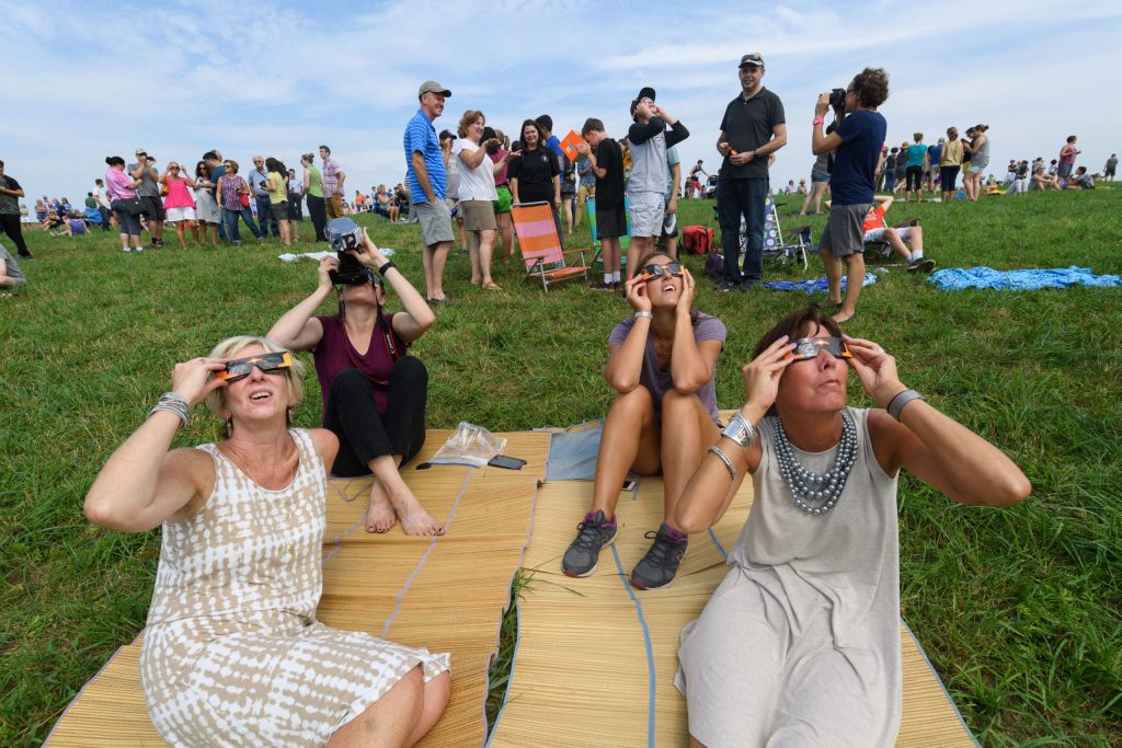 Jane Kelley-Sabatinos, Kristy Dahlstrom, Jennifer Griffin,and Staci Dupre, all staff at the office of undergraduate admissions, watch the solar eclipse from Horsebarn Hill