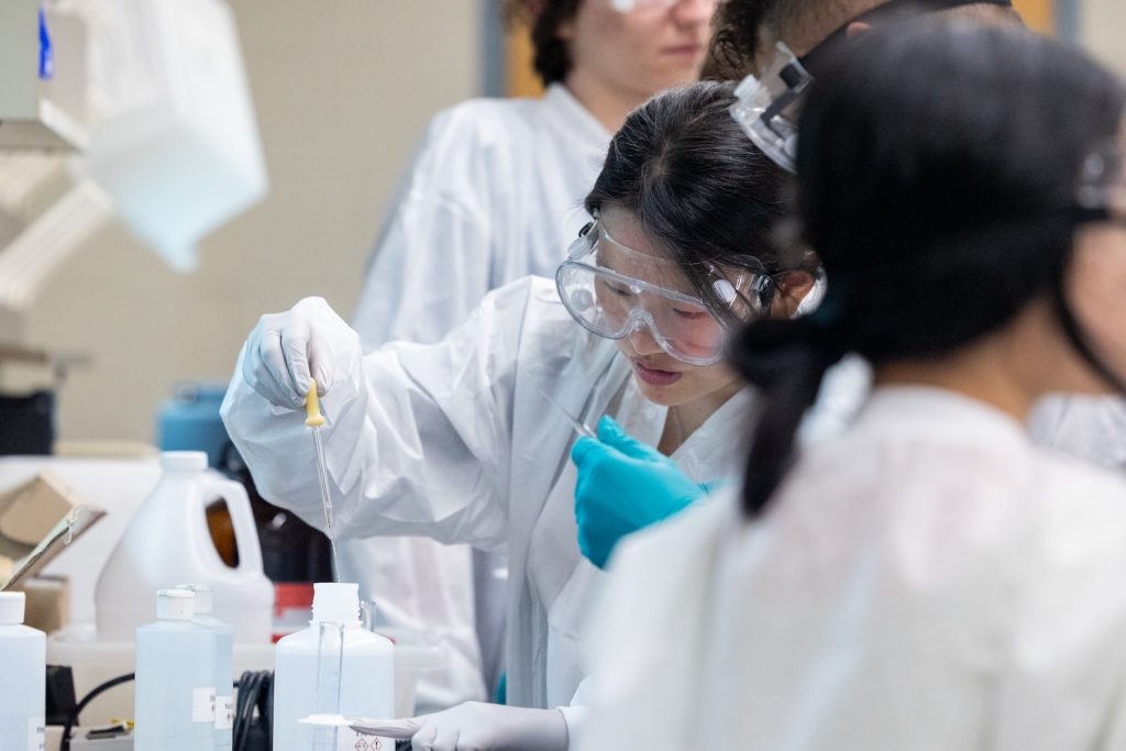 Student conducting chemistry experiment in lab