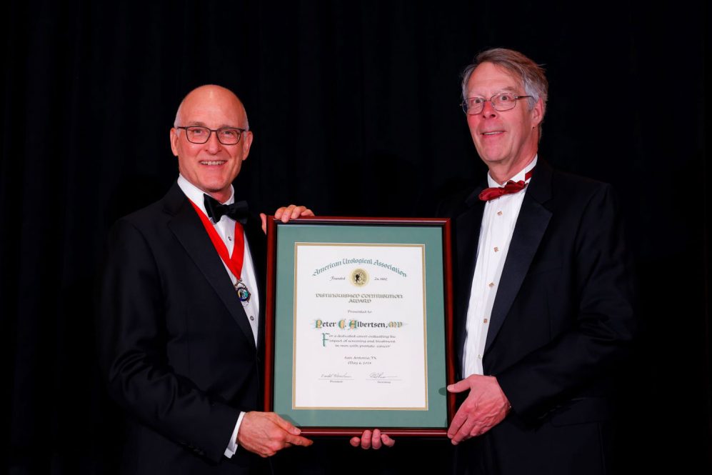 Two men holding a plaque