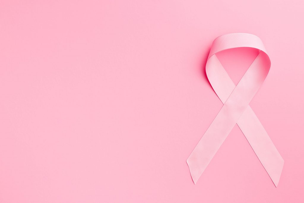 Pink ribbon breast cancer on pink background.