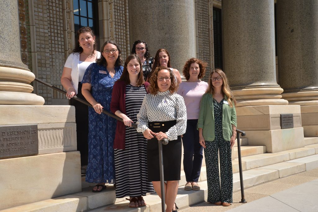 Female professionals stand on steps at UConn Hartford.