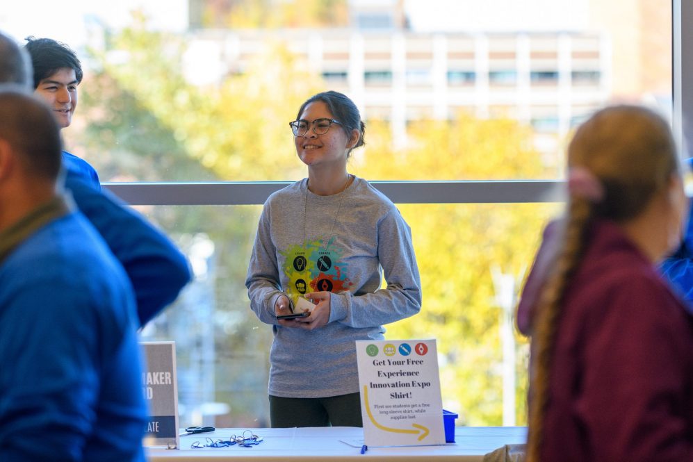 Faith Sportbert '23 (CLAS) works the shirt booth at the Innovation Expo