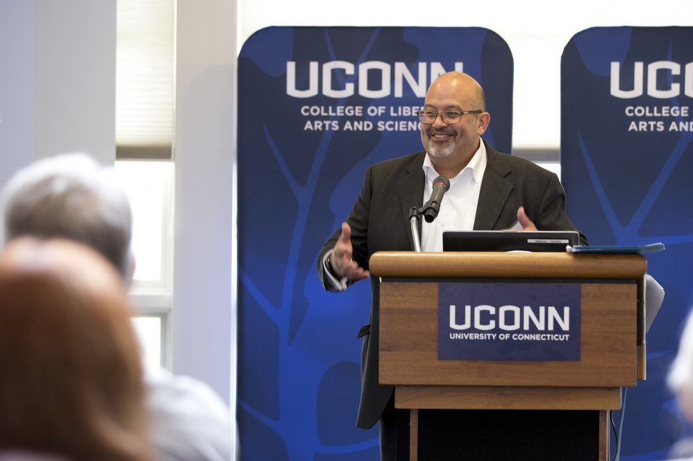 Charles R. Venator-Santiago speaks at a podium.