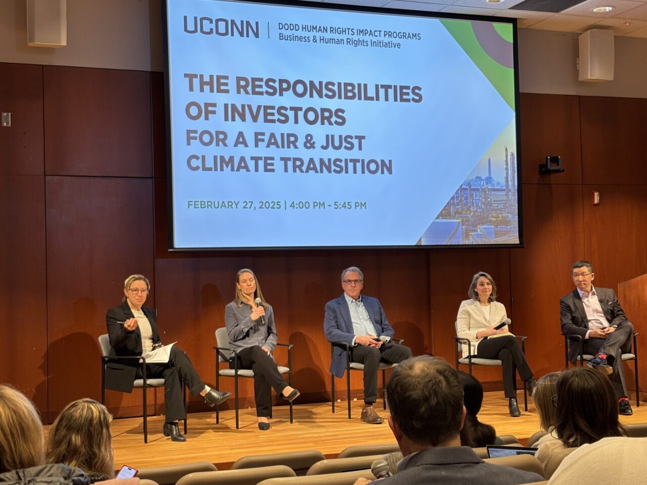 Five members of an academic panel sit on stage.